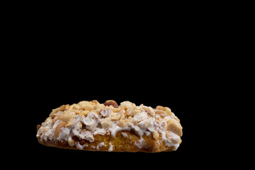 cookies with peanuts and white chocolate on black background.