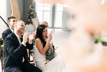 Guests applaud at the wedding ceremony.