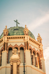 Fototapeta premium Cross on Green Roof of Ornate Church