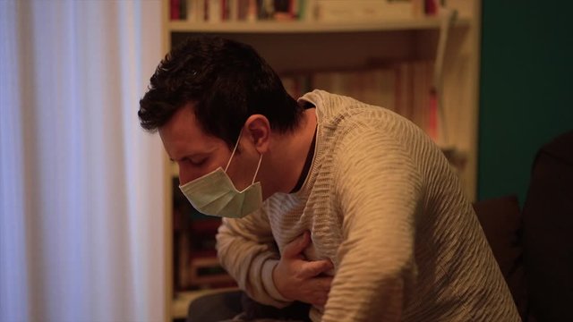 Young man with face mask to prevent coronavirus & PM 2.5 air pollution, man suffer from cough with face mask protection, Coronavirus 2019-nCoV from China.
