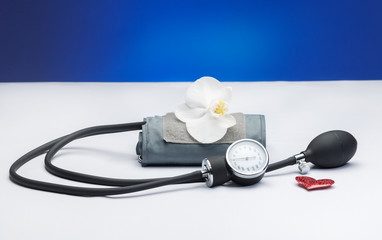 Black tonometer and heart isolated on white