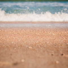 Sand on a Beach with Waves Splashing in Background