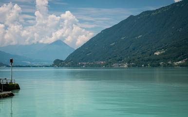 View of lake with clear turquoise water. Light haze on a hot summer day.