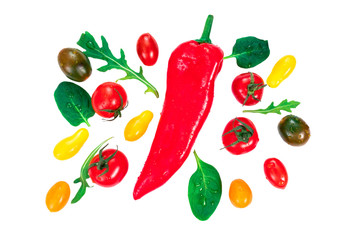 Creative layout made of cherry tomatos, red pepper and salad leaves. Bio food concept, top view