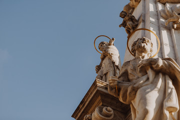 Fototapeta na wymiar 01.06.2019 Budapest, Hungary: photo of the plague monument which is installed in the central square in Budapest, a crucifix from below on the sky background