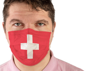 Portrait of adult caucasian man who wears protective mask on his face against influenza and protect health from bacteria. Flag of Switzerland.