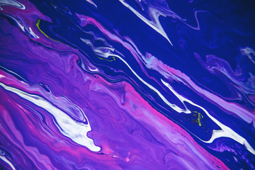 Acrylic paint liquid in trend purple and blue color mix background.