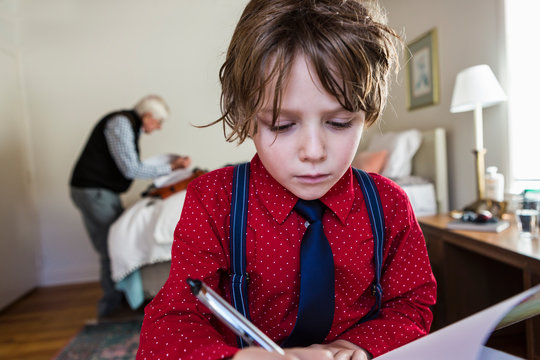 6 Year Old Boy Drawing On Sketch Pad In