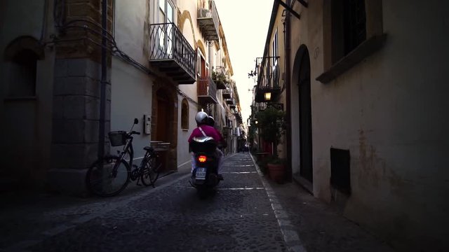 moped in Cefalu old town street, Sicily, Italy. Picturesque historic town on mediterranean seashore. Summer tourism landmark & family travel destination in Europe. Italian culture. 