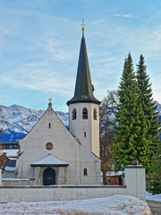 Fototapeta na wymiar Picturesque old church in Garmisch Partenkirchen on a clear winter day