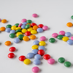 colorful medication and candies on white background