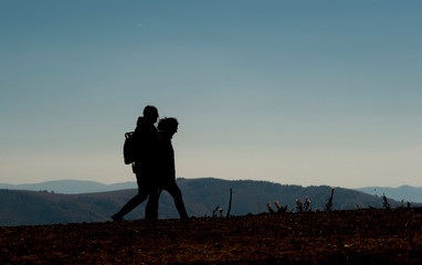 Two mountaineers walk through the mountain at dusk