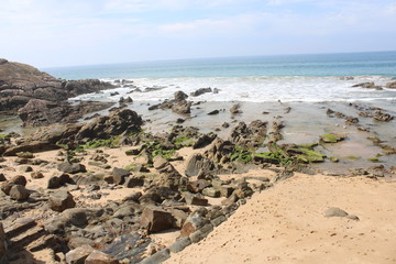 view of beach and rocks with blue sky