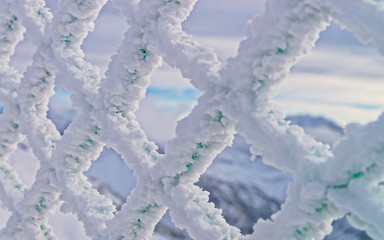 Fencing mesh being frozen in mountains in the winter time