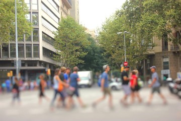 Pedestrians cross the street in Barcelona, Spain.