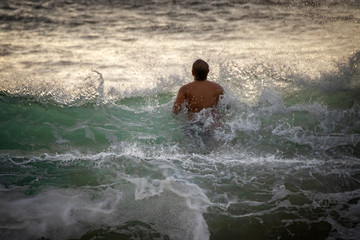 Man Jumps Through Breaking Wave in Ocean