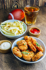 Table fof tasty snacks and beer prepared for watching sports on TV. Selective focus