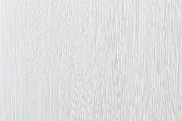 Texture of white paint with stains from a brush on the wall, background
