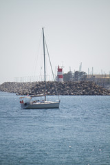 Boat in front of lighthouse in Portugal