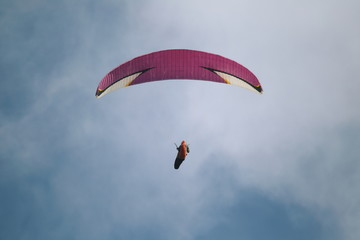 Paraglider in the air on a cloudy day