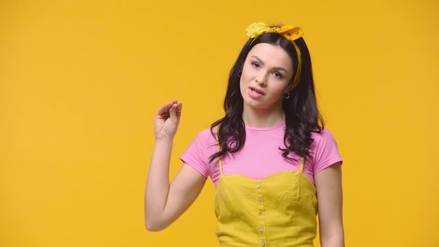 Skeptical woman showing speech isolated on yellow