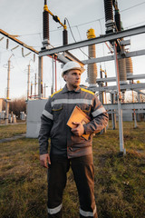 The energy engineer inspects the equipment of the substation. Power engineering. Industry