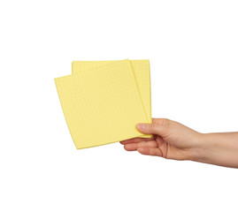 hand holds a yellow rag sponge for cleaning
