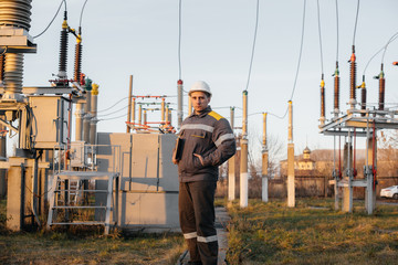 The energy engineer inspects the equipment of the substation. Power engineering. Industry