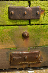 Rusted metal plates on a wooden groyne