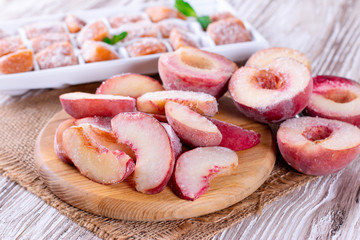 Frozen peaches on a wooden board