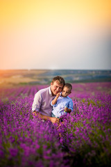 Father and son play on a beautiful lavender field. Vacation, vacation, family