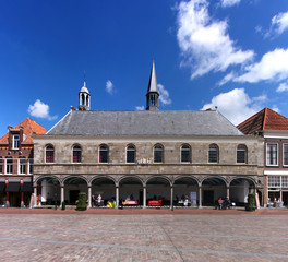 Gasthuiskerk church facade with its town hall like loggia at a market square in the old town of...