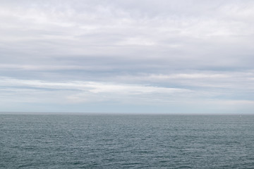 View towards the horizon of the infinite sea in a cloudy day in Donostia, San Sebastian, Spain