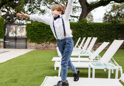 6 year old boy standing on lawn chair