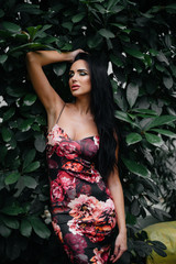 A young beautiful brunette posing among dense thickets of jungle and rainforest. Spa