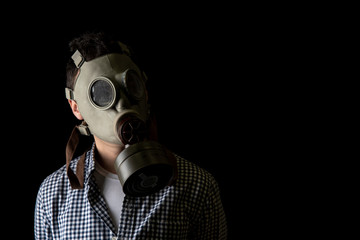man in a gas mask on a black background. copy space