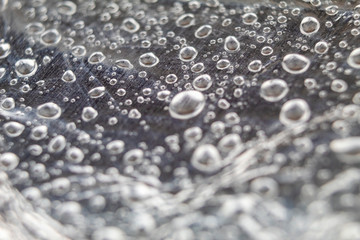 Background macro Drops of water on silver