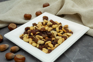 Raisins and nuts interspersed on a marble background