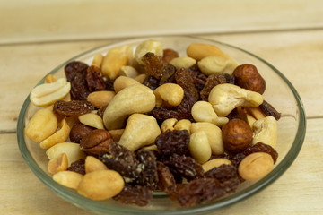 Raisins and nuts scattered on a wooden background