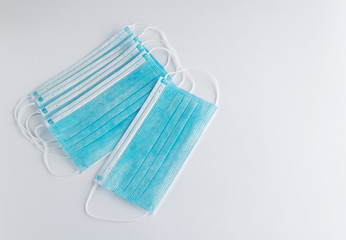 Set of surgical masks with rubber ear straps on white background. Top view.