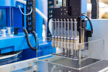 Automatic ampoule filling machine at pharmacy factory or medical exhibition. Pharmaceutical...