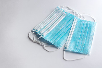 Set of surgical masks with rubber ear straps on white background.