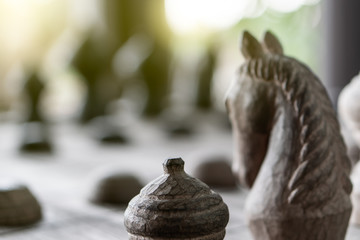 Background of wooden Thai chess game horse, king, queen, pawn on game board for strategy concept. Business strategic to thinking planning to lead during risk virus crisis management economic downturn