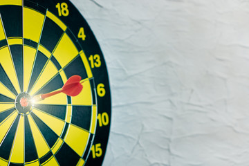 Background with symbol concept of business success achievement focus with red dart game aim and hit center target spot on dartboard for professional winning