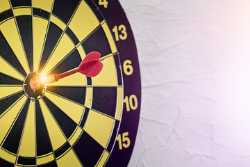 Background with symbol concept of business success achievement focus with red dart game aim and hit center target spot on dartboard for professional winning