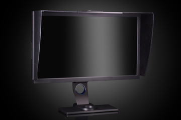 Professional photographer monitor with shading hood isolated on black