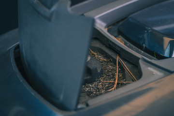 Dirty knob of robotic lawnmower, motorized lawnmower being serviced on a table after a year of use in the mud and grass. Regular maintenance of robotic lawnmower