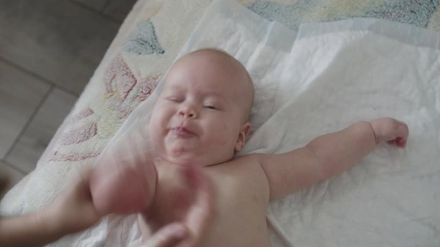 View of baffled babyborn twisting during an arm massaging