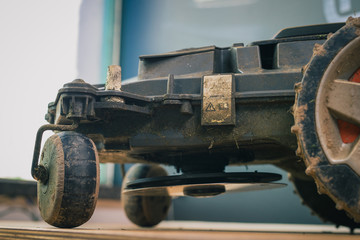 Warranty seal sticker visible on motorized lawnmower being serviced on a table after a year of use...