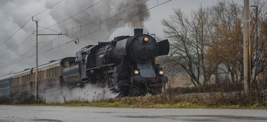 Old vintage steam train with black locomotive